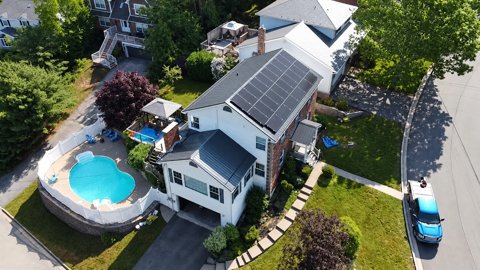 Two-storey home with rooftop solar beside a backyard pool