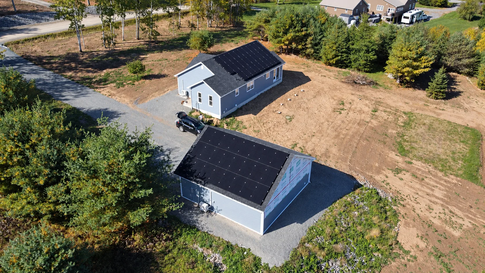 House and detached garage, both with rooftop solar panels