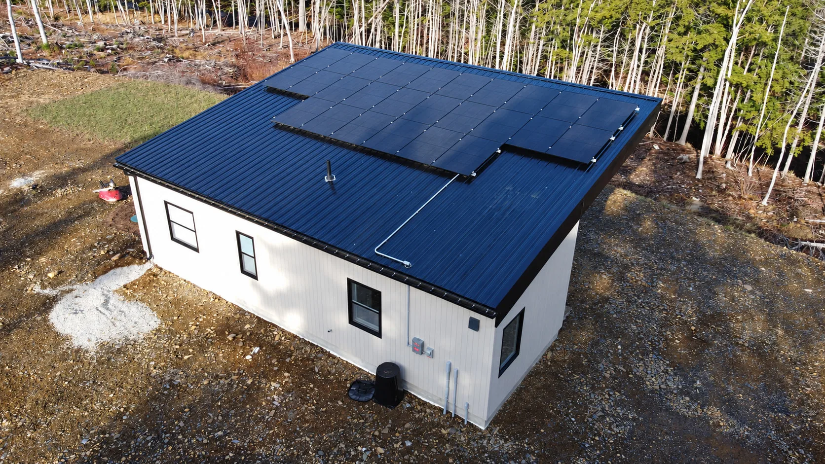 Single-storey home with a dark metal roof covered in solar panels