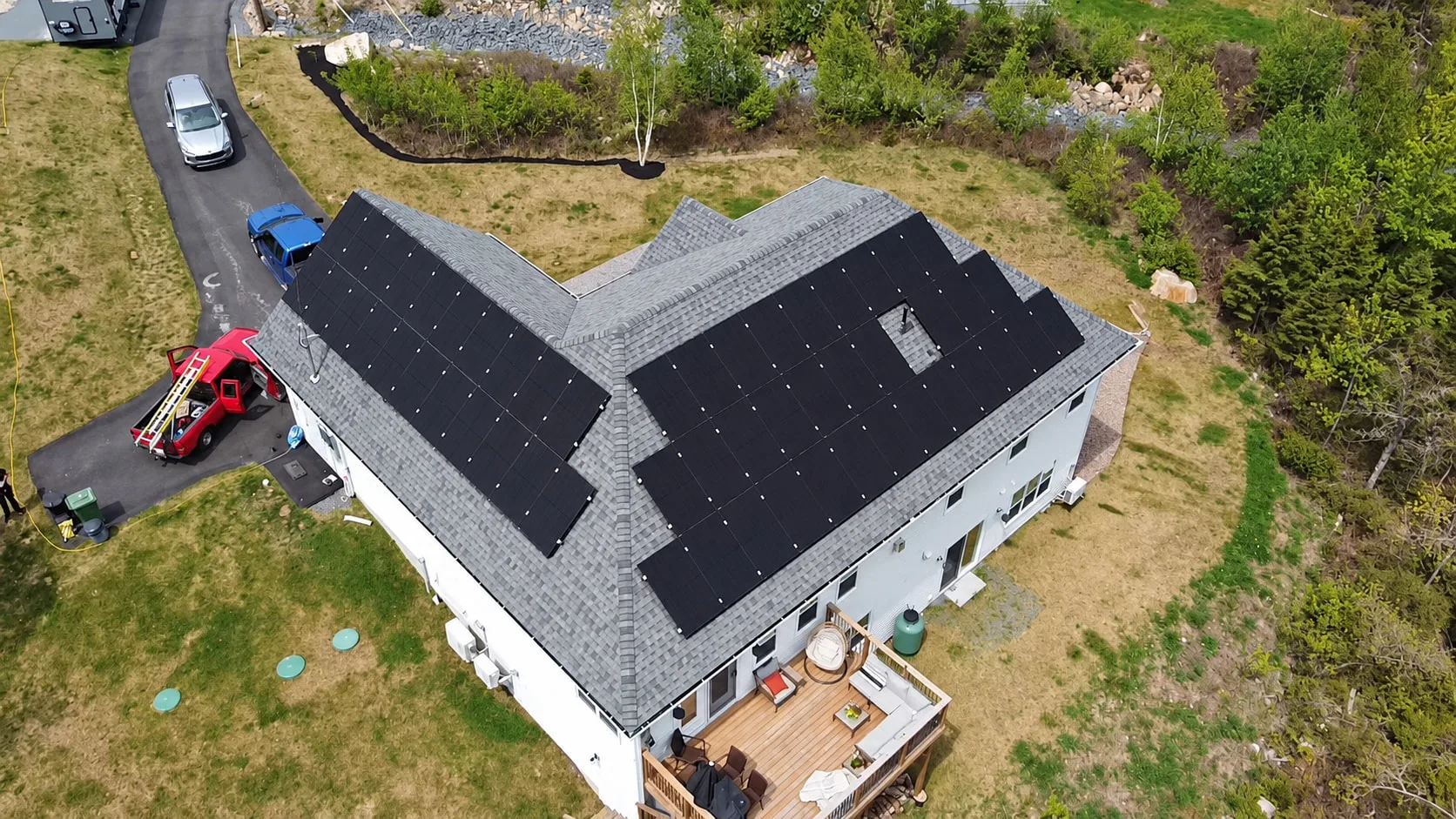 Home with solar panels on two roof sections, seen from above