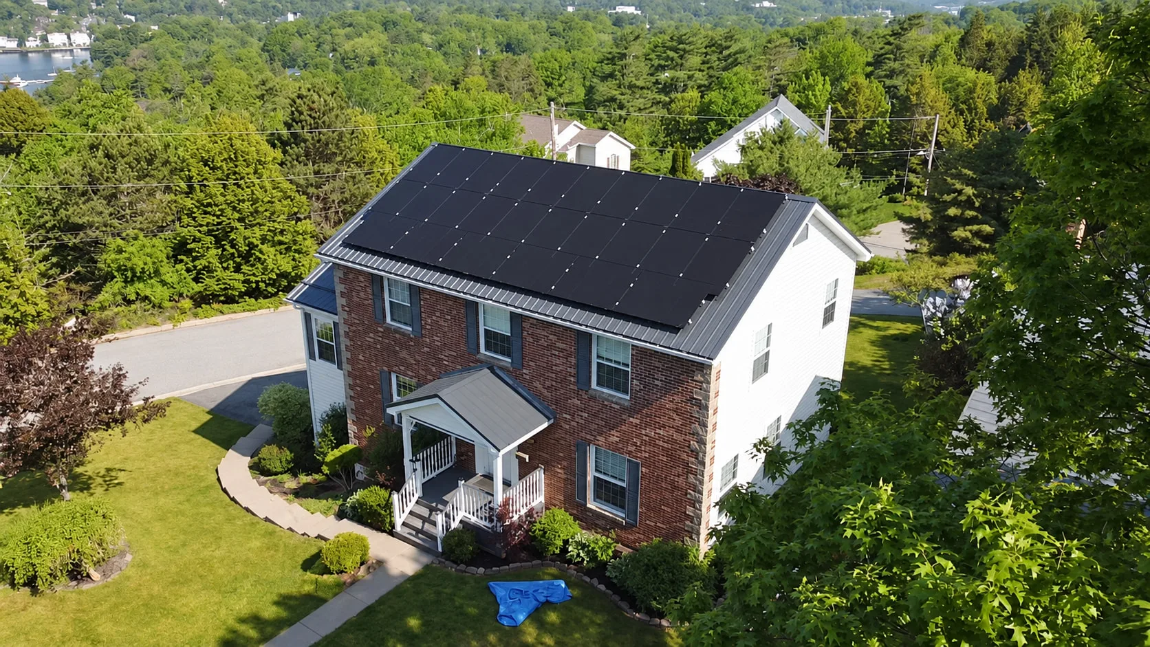 Brick colonial home with a full solar array across its front roof