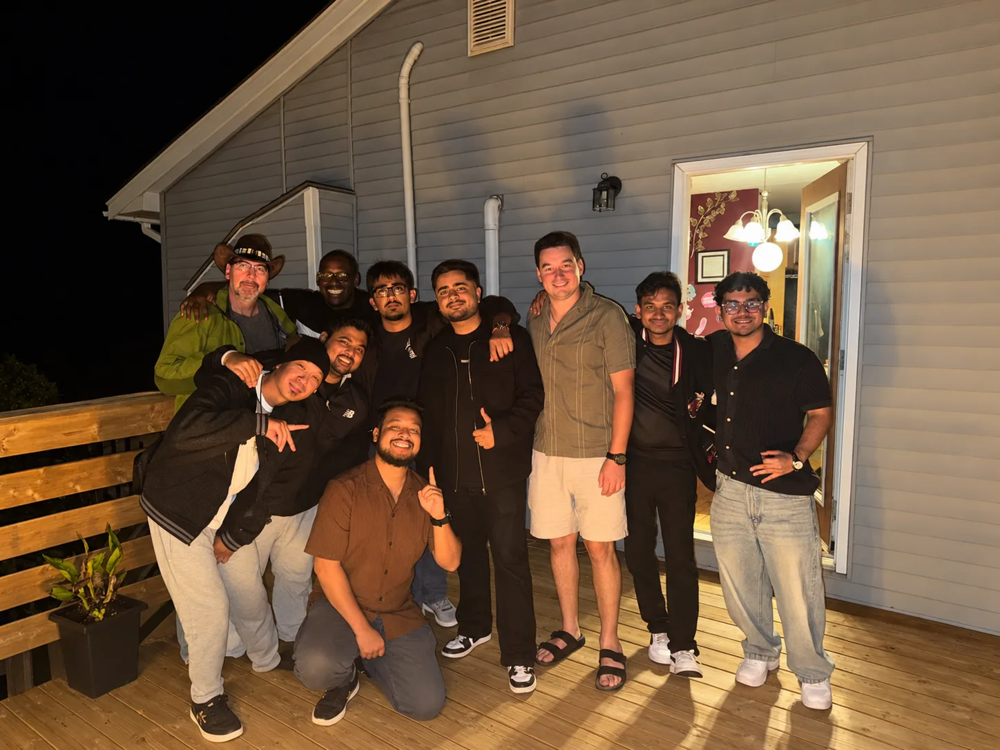 The JC Power team together on a deck in the evening